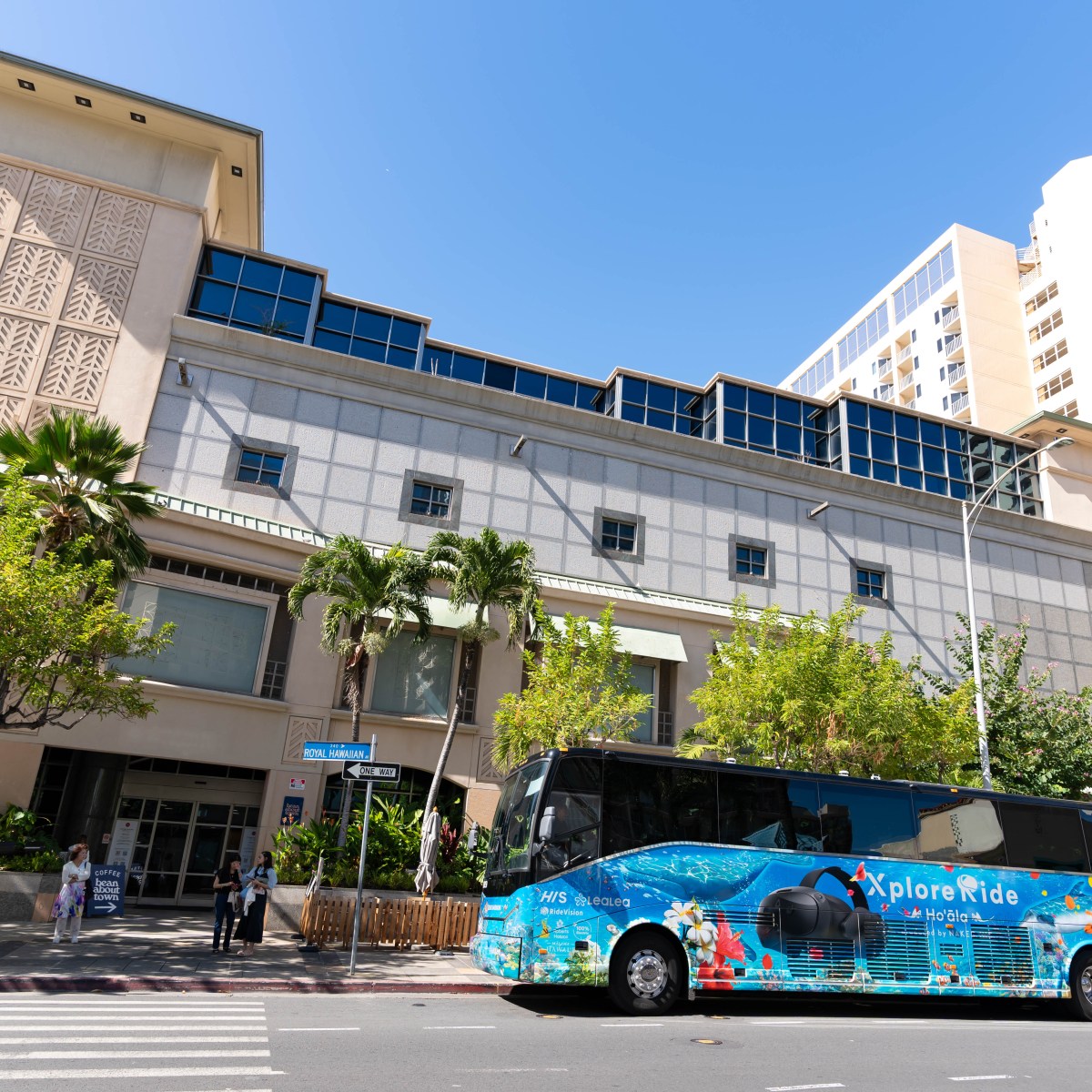 a car driving down a street in front of a building