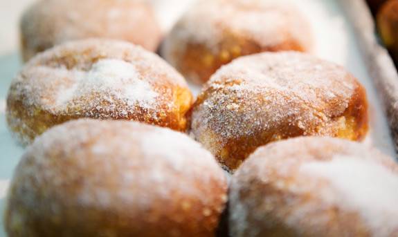 Close-up of sugar-coated pastries on a tray.