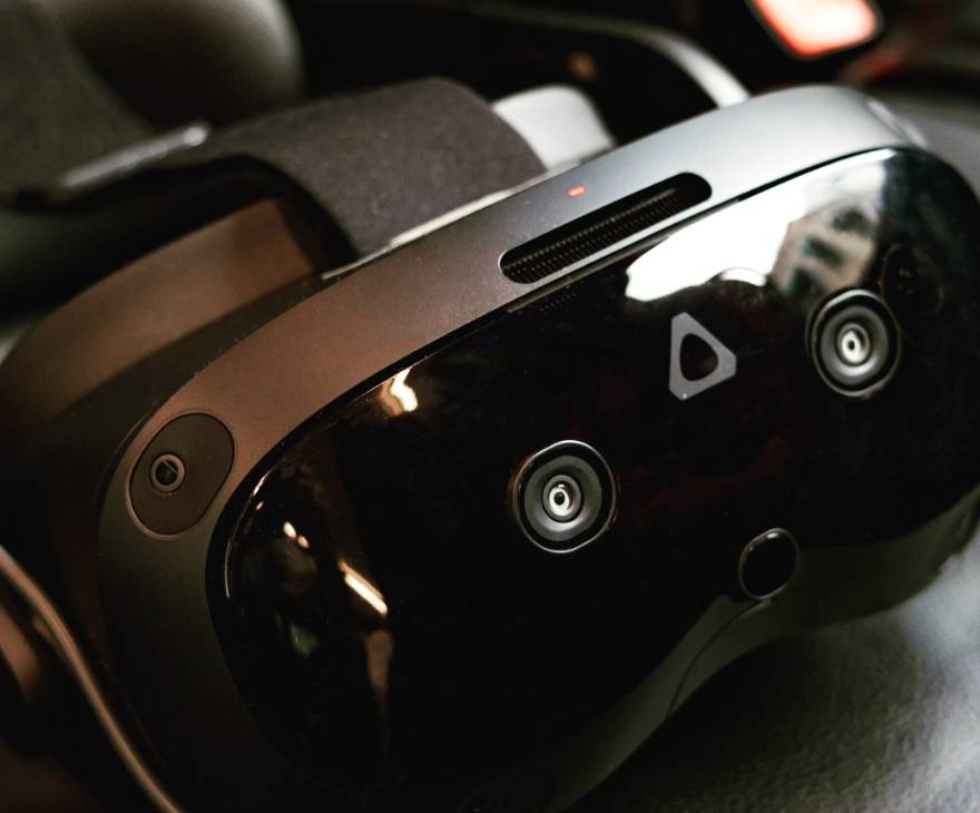 Close-up of a VR headset with multiple sensors and black straps.