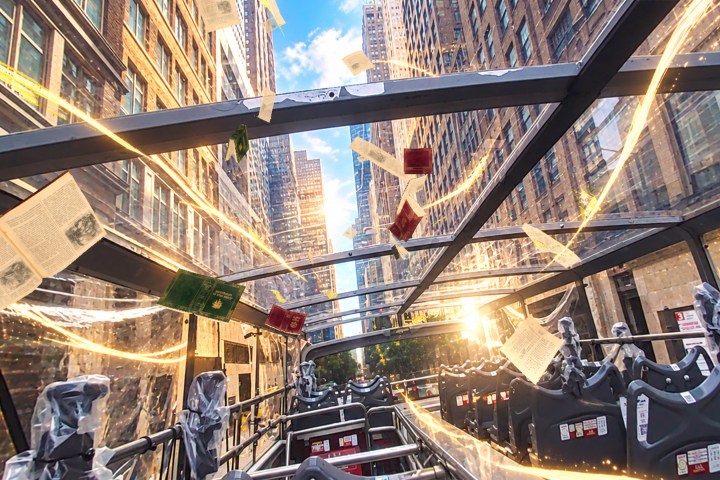 Open-top bus with floating books and pages on a city street with tall buildings.